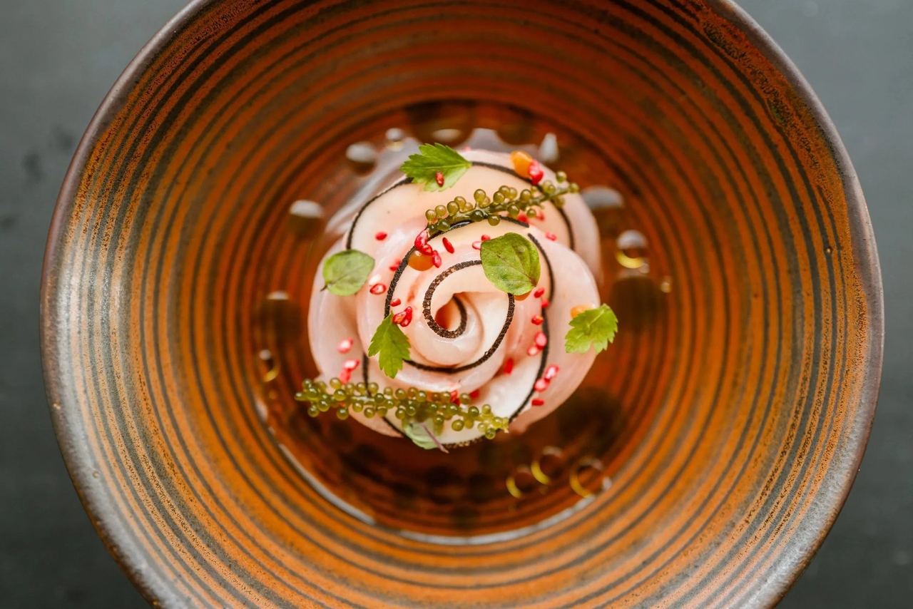 A rose of raw fish with sea grapes and herbs in a ridged earthenware bowl at D’Olier Street