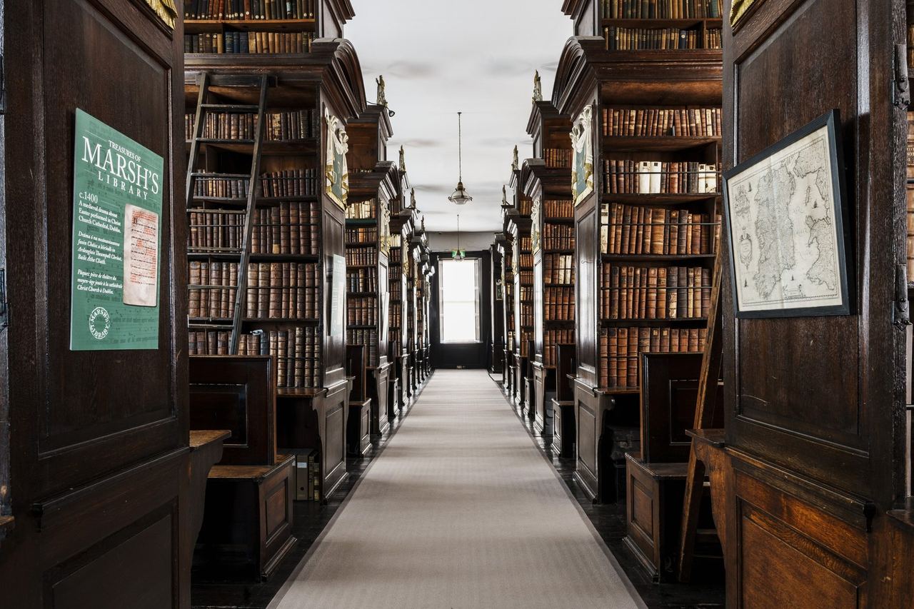 The dark oak bookcases of Marsh’s Library, a long gallery of 18th-century volumes